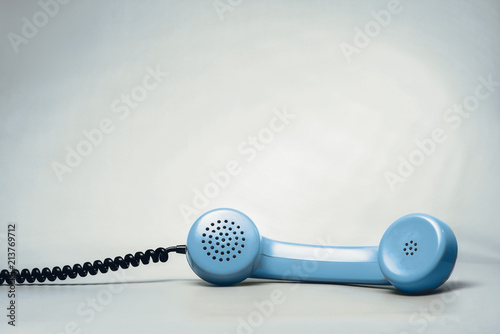Blue telephone on blue background