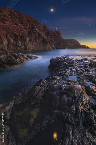 Rocky coastline with lighthouse on the moonset. Punte del Teno,tenerife © Mike Mareen