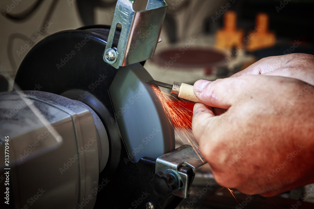 Sharpening the metal cutter on the grinding machine