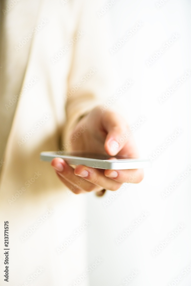 Woman hands hold cell phone on light cream background with copy space. Banner. Business, study, remote work, always connect concept. Smartphone. Woman hands hold cell phone on light cream background with copy space. Banner. Business, study, remote work, always connect concept. Smartphone.