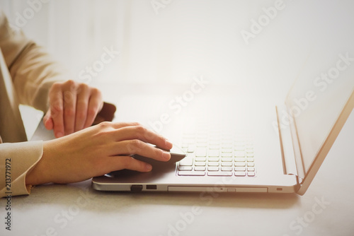 Business, remote work, always connect, online banking, online shopping concept. Freelancing woman using laptop computer for distance job at home. Copy space. Light bokeh concept