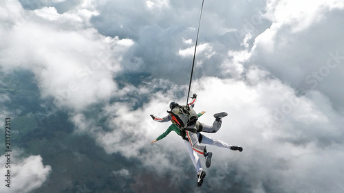 Skydiving tandem falling into the clouds