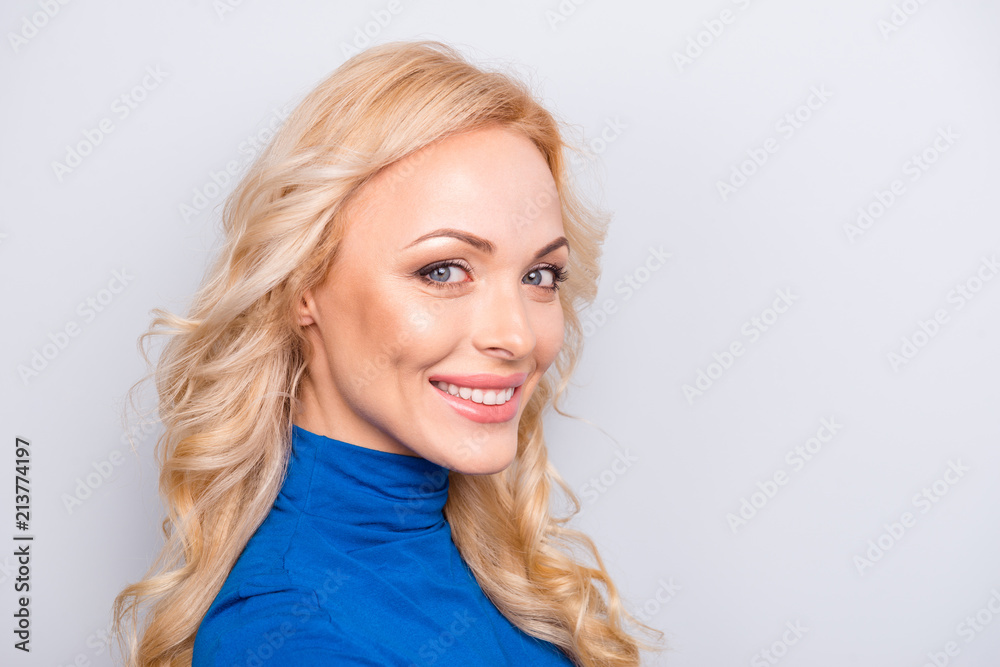 Close up portrait of pretty, trendy, charming,  nice, sexy, cute woman isolated on grey background looking at camera wearing blue roll neck having beaming smile