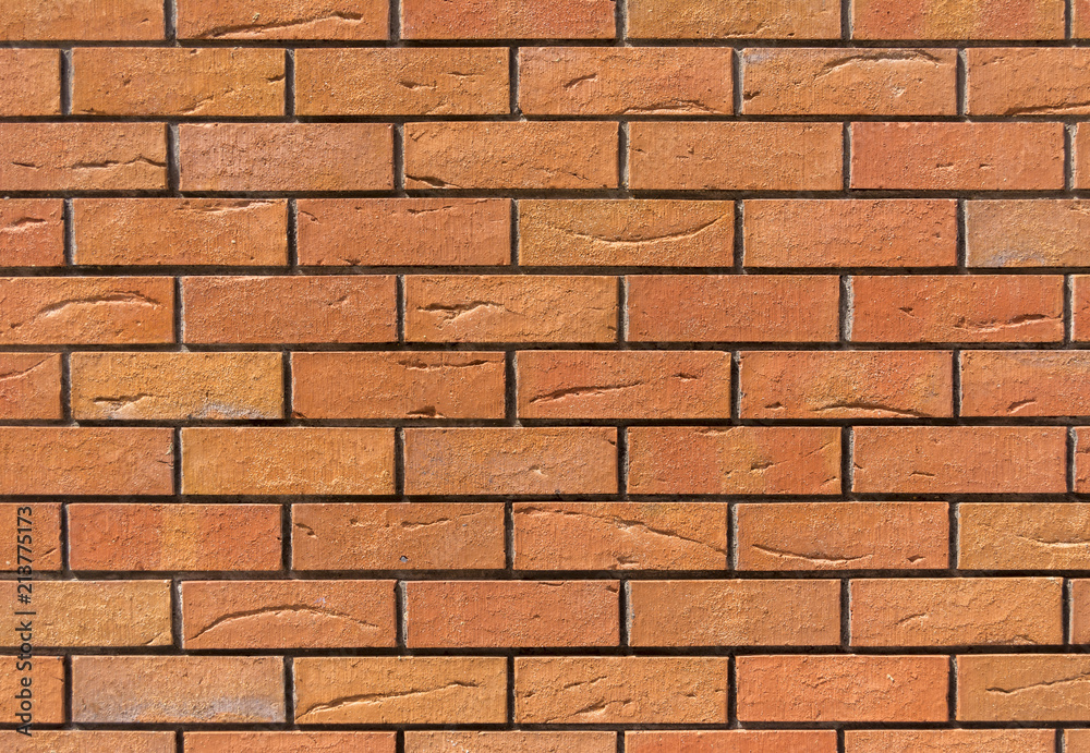 Red brick wall. Decorative brick with artificial defects and cracks. Red brick wall. Decorative brick with artificial defects and cracks.