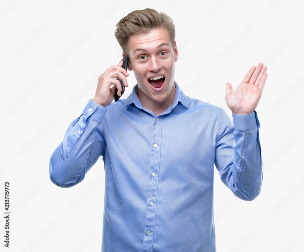 Young handsome blond man using smartphone very happy and excited, winner expression celebrating victory screaming with big smile and raised hands Young handsome blond man using smartphone very happy and excited, winner expression celebrating victory screaming with big smile and raised hands