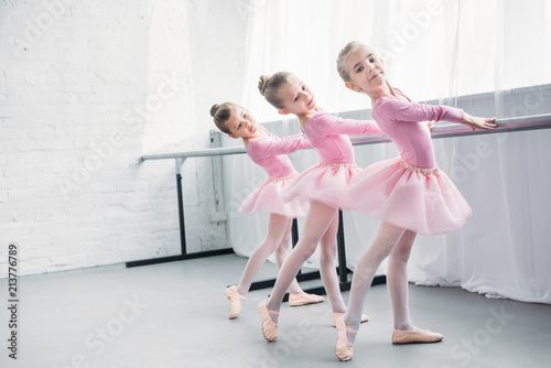 graceful elegant little ballerinas practicing together in ballet studio