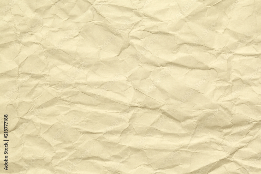 Obraz premium Paper beige color aged and wrinkled. Background of brown color with kinks and fraying.