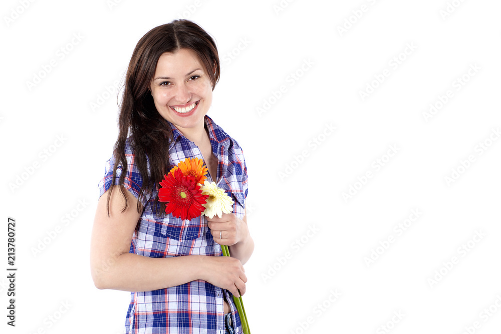 Smiling young woman in a plaid shirt with gerbera flowers isolated on white Smiling young woman in a plaid shirt with gerbera flowers isolated on white