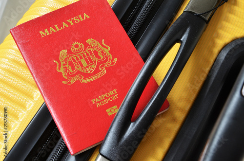  Malaysia passport on a yellow suitcase photo