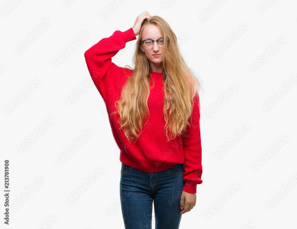 Blonde teenager woman wearing red sweater confuse and wonder about question. Uncertain with doubt, thinking with hand on head. Pensive concept. Blonde teenager woman wearing red sweater confuse and wonder about question. Uncertain with doubt, thinking with hand on head. Pensive concept.