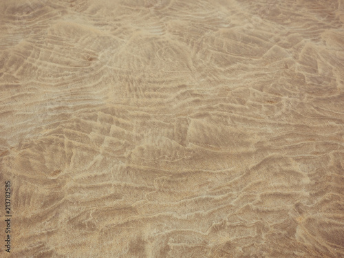 abstract pattern made by tide on sandy beach