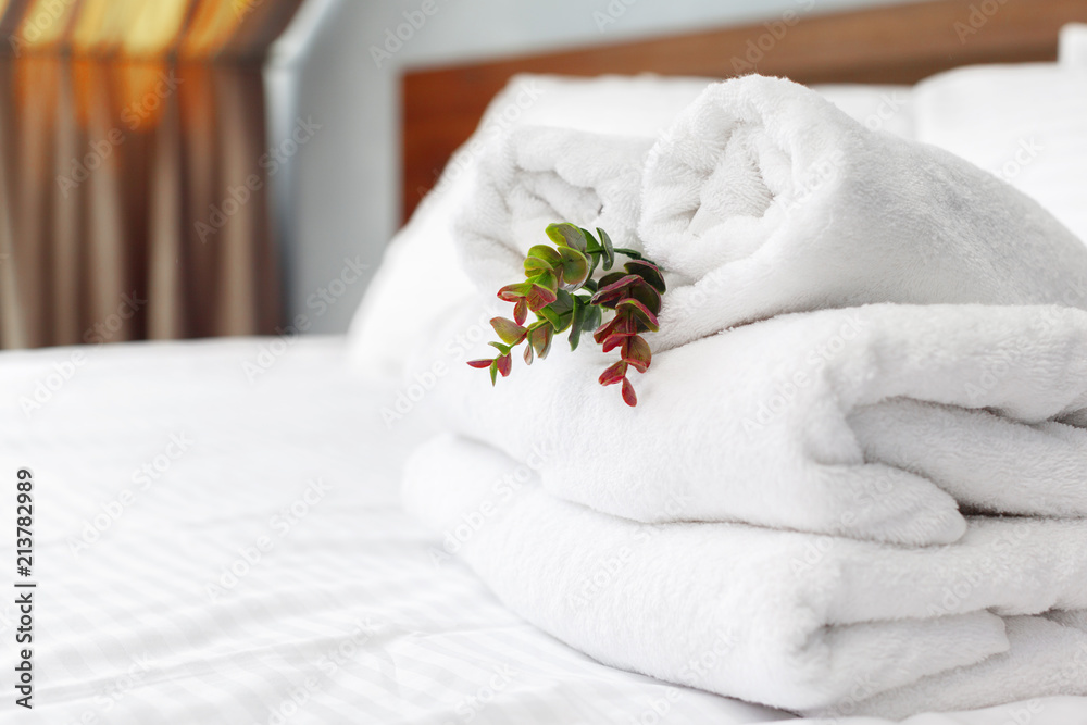 towels and flower on bed in hotel room towels and flower on bed in hotel room
