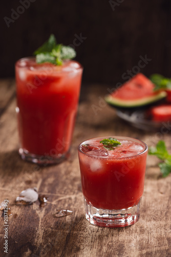 Refreshing summer watermelon juice in glasses with slices of watermelon
