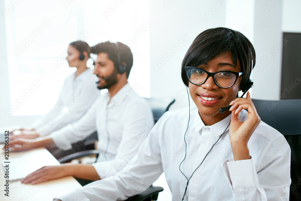 Call Center Operator With Colleagues At Workplace Call Center Operator With Colleagues At Workplace