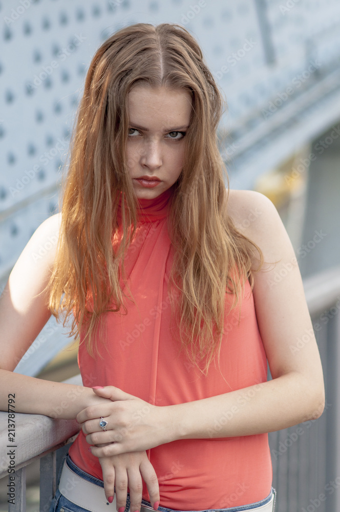 Beautiful young girl with long hair dreamily waiting at the bridge
Beautiful young girl with long hair dreamily waiting at the bridge