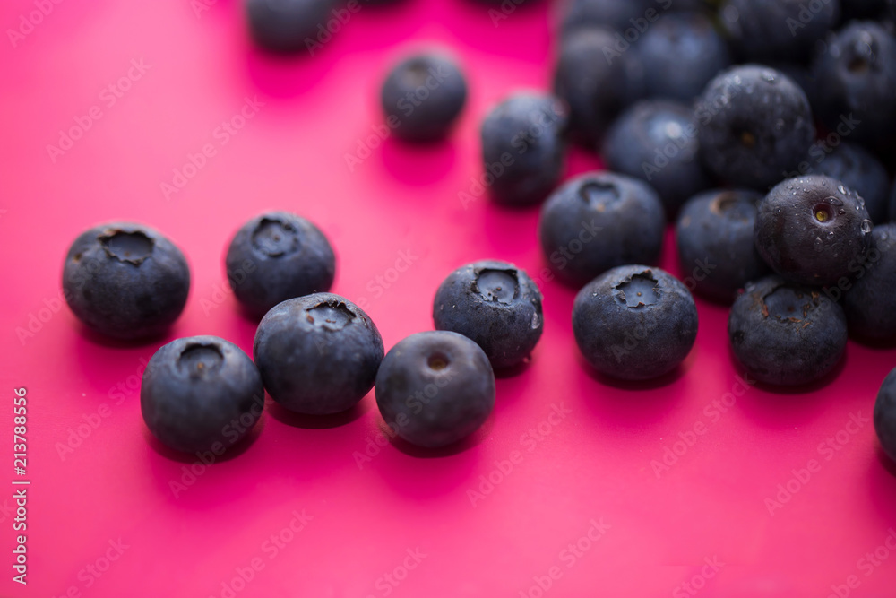 Group of blueberries on a pink background close-up. Group of blueberries on a pink background close-up.