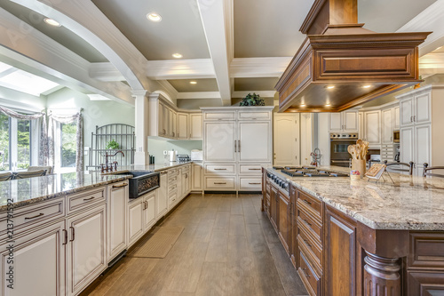 Stunning kitchen room design with large bar style island. © Javani LLC
