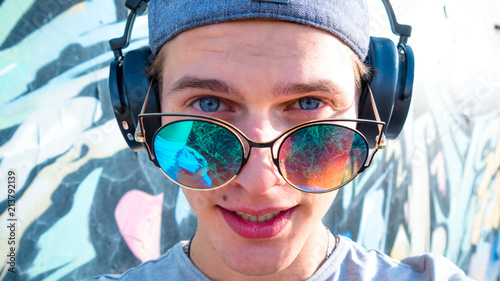 Young man sunglasses headphones portrait