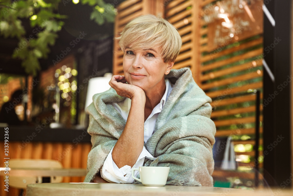 Fototapeta premium Lovely mature woman wrapped in blanket