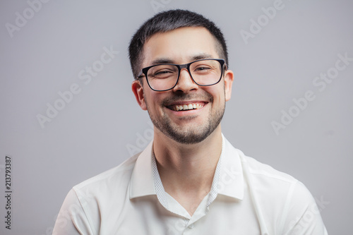 carefree positive male in glasses. cheerful man rejoicing at the good business news photo