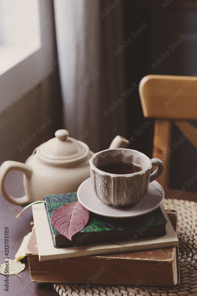cozy autumn morning at country house, cup of tea and books on wooden table. Still life details cozy autumn morning at country house, cup of tea and books on wooden table. Still life details