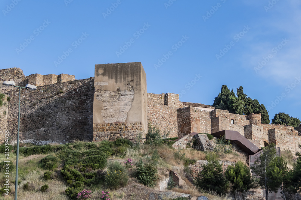 External view of Alcazaba Walls - palatial fortress in Malaga built in XI century. Fortress palace, whose name in Arabic means citadel, is one of city's historical monuments. Malaga, Andalusia, Spain.