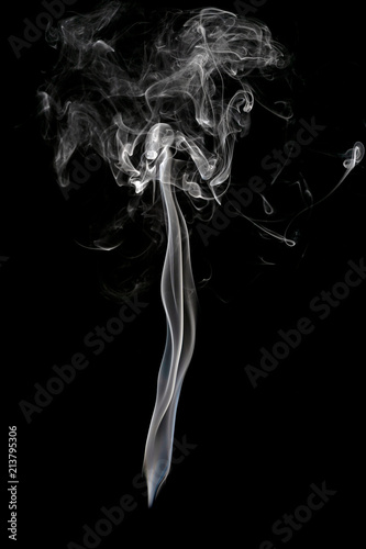 Abstract beautiful art. White smoke from the incense isolated on a black background.
