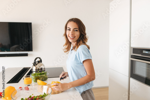 Smiling young girl making healthy lunch