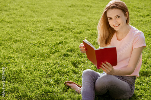 girl on the lawn reading a book