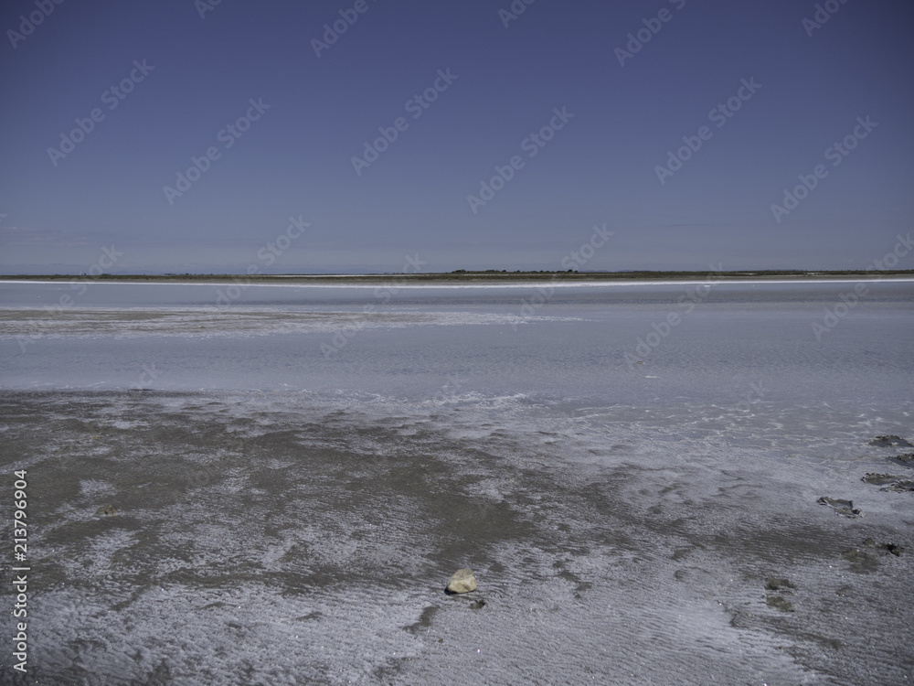 Horizon between blue sky and salt flat