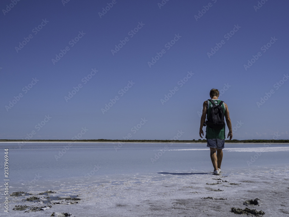Young man walking away in the nature