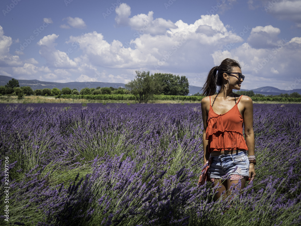Asian woman solo traveller enjoying the full blooming of lavender field in Provence, France
