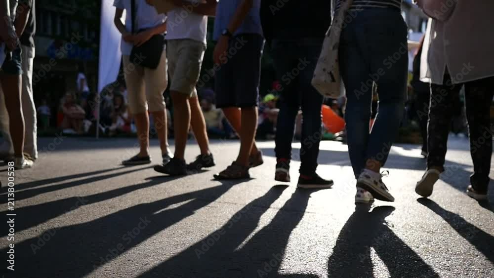 People legs walk a pedestrian asphalt street slow motion during urban festival in Sofia People legs walk a pedestrian asphalt street slow motion during urban festival in Sofia