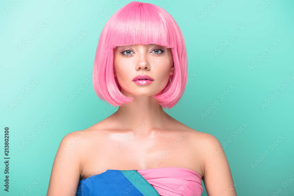 young woman with pink bob cut looking at camera isolated on turquoise young woman with pink bob cut looking at camera isolated on turquoise