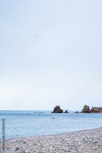 Beach with rocks in the background