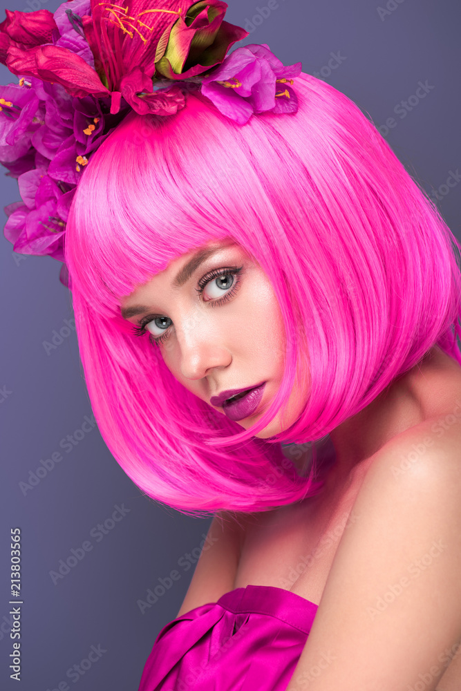 beautiful young woman with pink bob cut and flowers in hair looking at camera isolated on violet beautiful young woman with pink bob cut and flowers in hair looking at camera isolated on violet