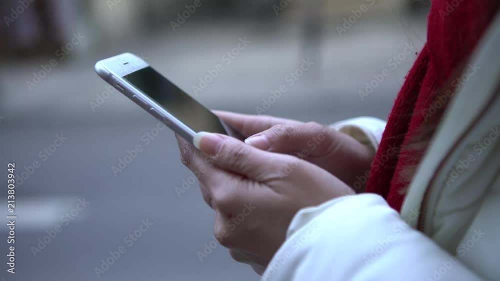 4K, Close up of asian woman using smartphone in street of France city. Female hand hold and touch screen cell phone. People surfing internet, checks social network and write text on device mobile-Dan 4K, Close up of asian woman using smartphone in street of France city. Female hand hold and touch screen cell phone. People surfing internet, checks social network and write text on device mobile-Dan