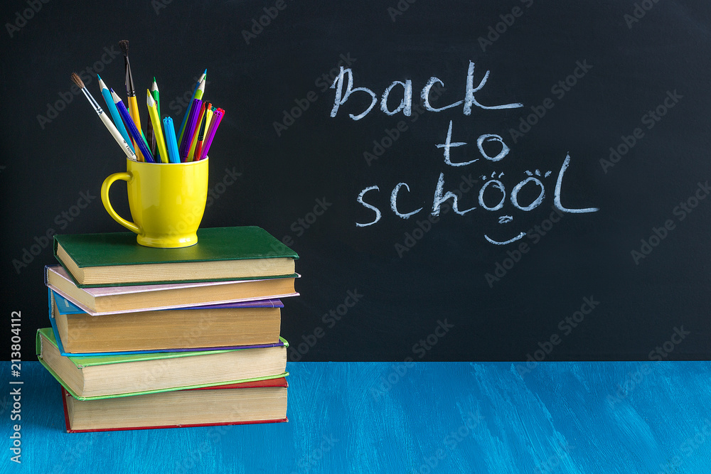 Workplace pupil Books Stationery on blue table on background bl Workplace pupil Books Stationery on blue table on background bl