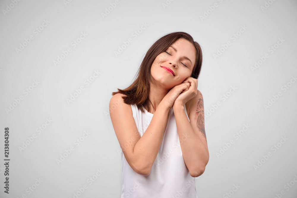 Beautiful positive friendly-looking young european girl with lovely sincere smile feeling thankful and grateful. Portrait of a gorgeous elegant dreamy brunette beauty Beautiful positive friendly-looking young european girl with lovely sincere smile feeling thankful and grateful. Portrait of a gorgeous elegant dreamy brunette beauty