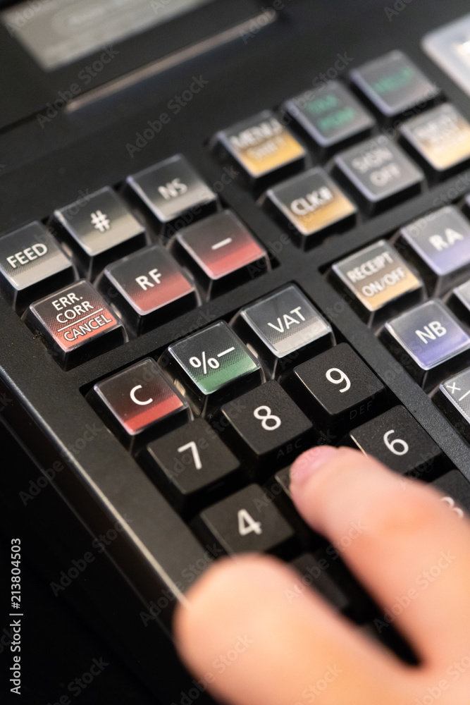 cash register installed on counter for accepting order from customer.sales man entering amount on electronic cash register in coffee shop and retail store.restaurant cashier typing on cash register. cash register installed on counter for accepting order from customer.sales man entering amount on electronic cash register in coffee shop and retail store.restaurant cashier typing on cash register.
