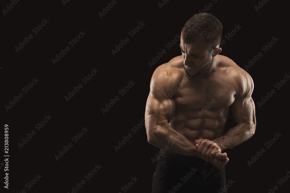 Naklejka premium Strong athletic man showes naked muscular body