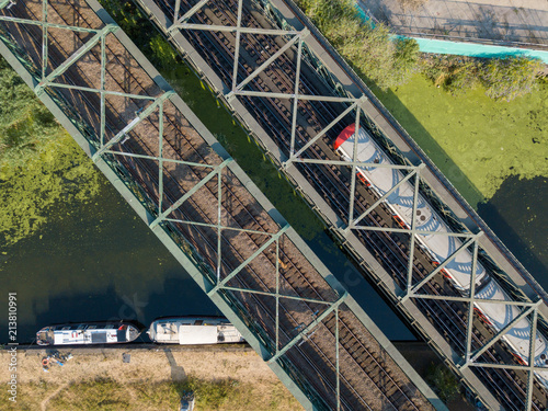 Canal and metro train bridge transportation infrastructure view from above with a drone