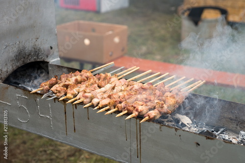 Shish kebab on skewers fried on charcoal grill. photo