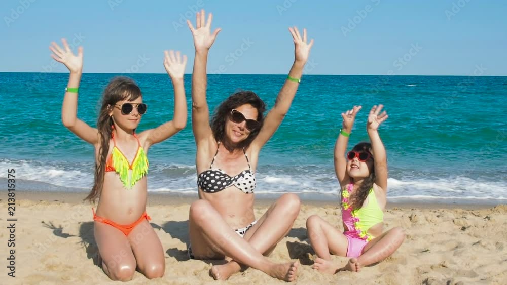 Children and mom are happy on the beach. Children and mom are happy on the beach.