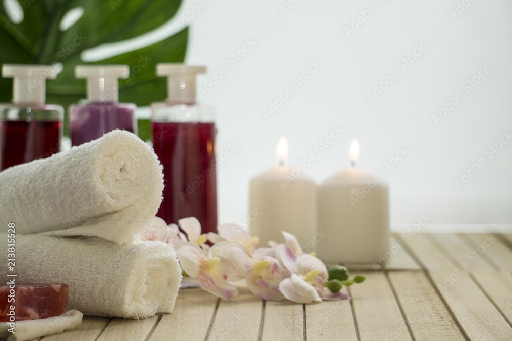 Items for spa, baths, saunas in still life: towels, soap, shampoo and rose