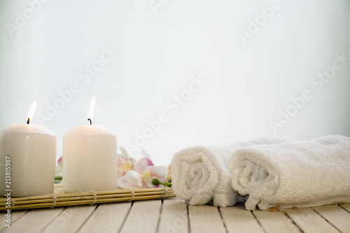 Fototapeta Naklejka Na Ścianę i Meble -  Spa setting still life with orchid flower , candle, soap and towels on white background