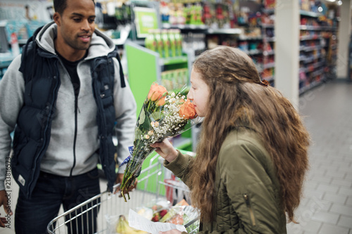 Smelling Flowers in the Supermarket © dglimages