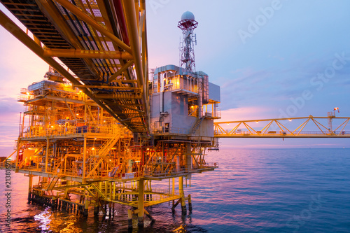 Offshore construction platform for exoloration and production oil and gas with bridge in evening time for power energy of the world concept © Goodvibes Photo