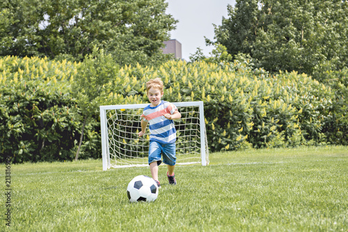 Young caucassian soccer player football outside