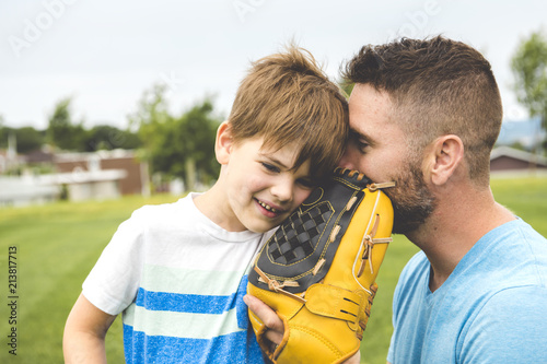 Photography Handsome dad with his little cute sun are playing baseball on green grassy lawn